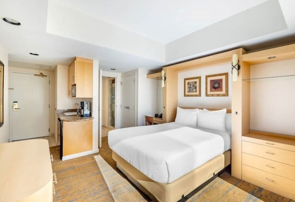 Unwind in crisp linens with a handy in-room kitchenette.