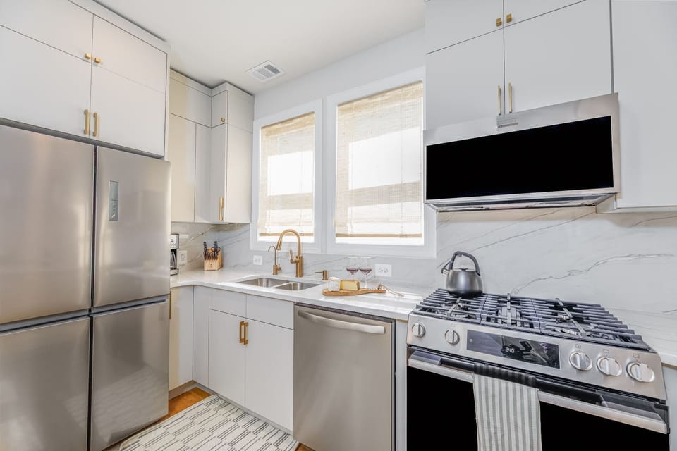 Welcome to the chef's kitchen! We fully renovated it with sleek modern cabinetry, high-end stainless steel appliances, and elegant gold Moen hardware.