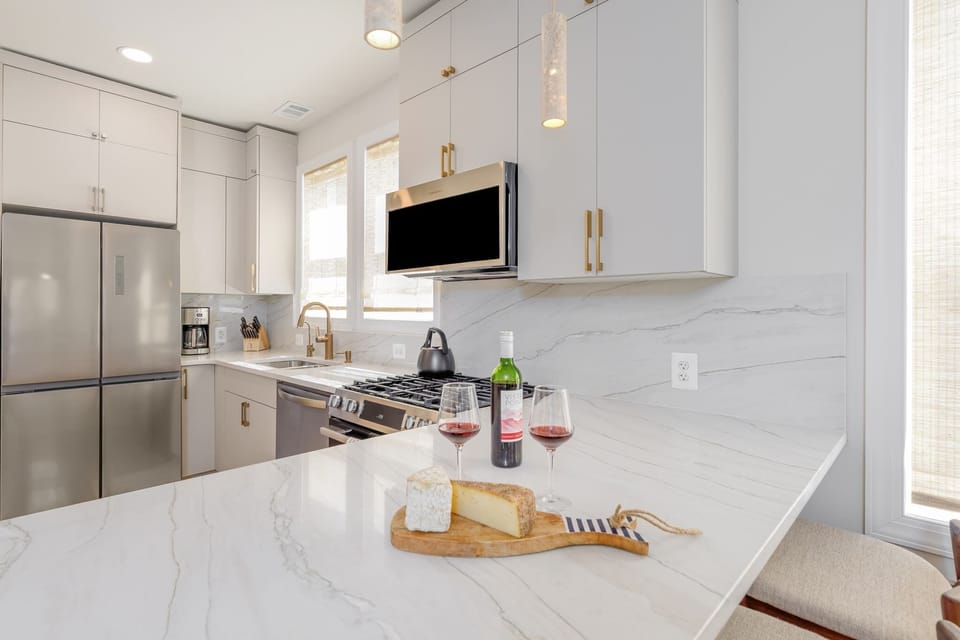 We love this view of the solid quartz countertops and full-height quartz backsplash—the perfect backdrop for serving up a fresh charcuterie board.