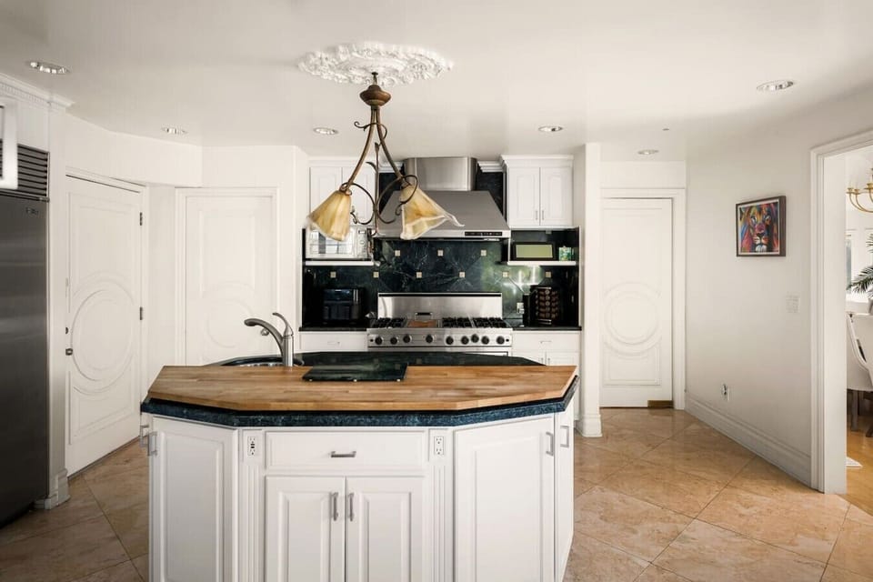 Spacious kitchen with premium appliances, center island, and seamless flow to dining and living areas.