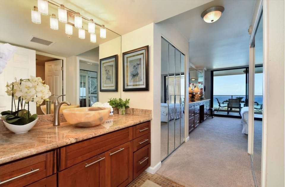 Unit 1: Enjoy a well-lit vanity area with modern finishes and easy access to the bedroom
