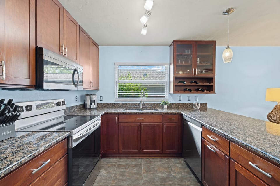 Fully equipped modern kitchen with granite countertops, stainless steel appliances, and everything needed for dining and entertaining.