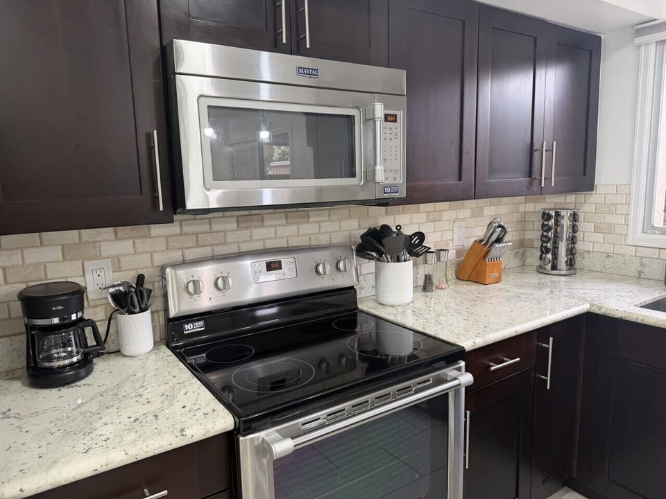 Modern kitchen with stove, microwave and coffee maker
