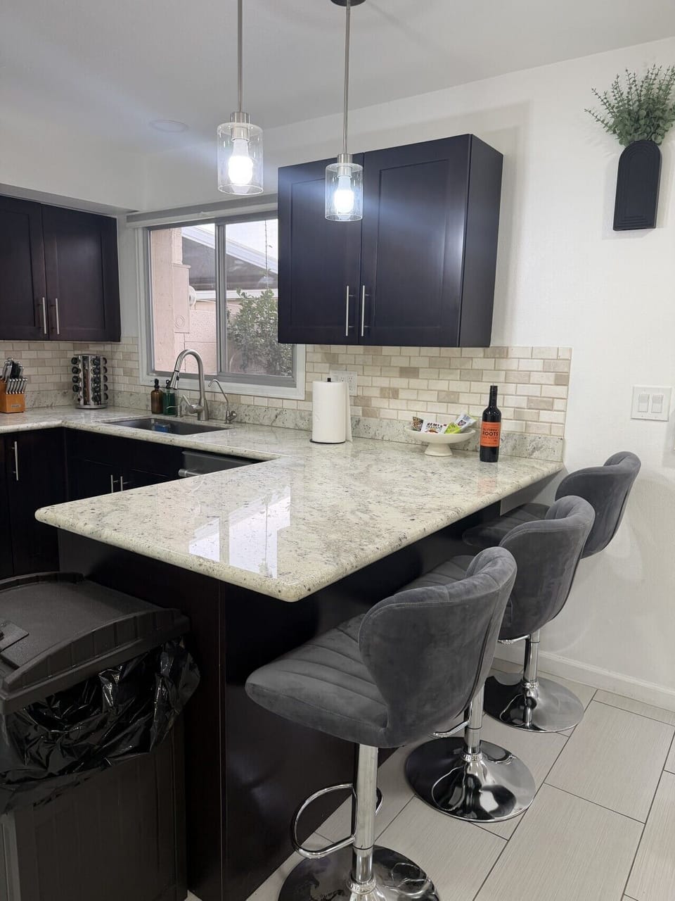 Kitchen bar counter with sink and stylish pendant lighting