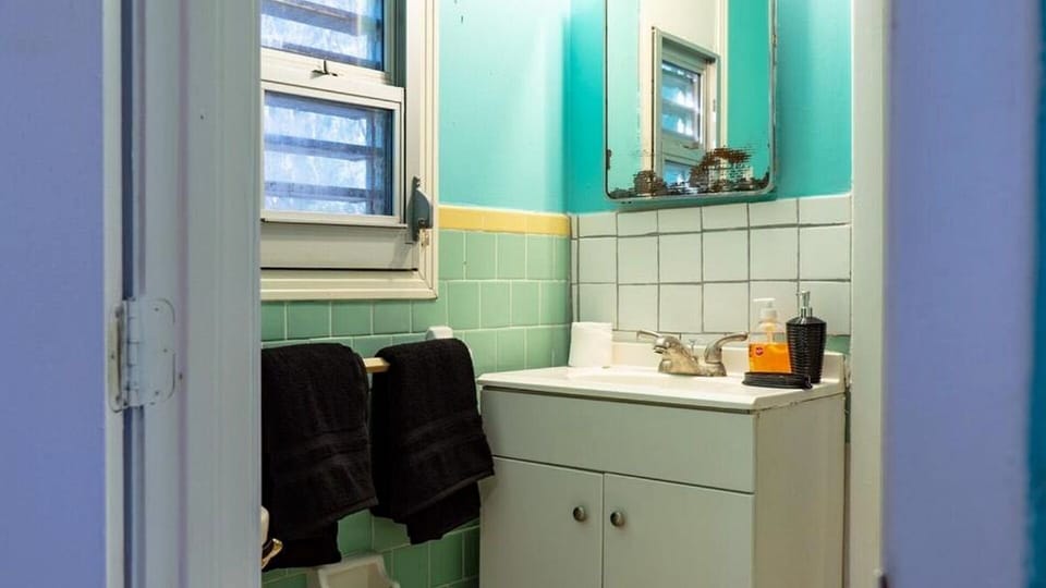 Bathroom vanity, toilet, and towels