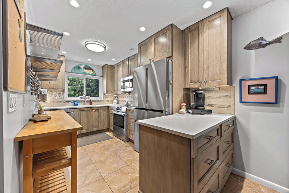 Modern kitchen with stainless steel appliances and natural wood cabinetry