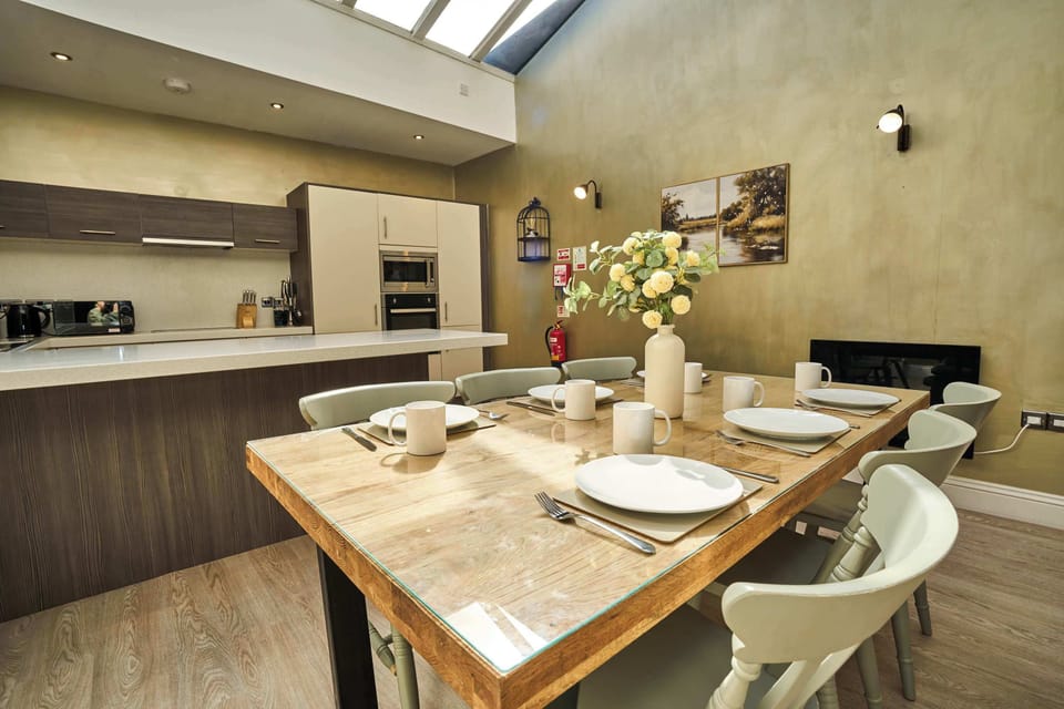 Sun-drenched and spacious. Our modern kitchen flows seamlessly into a beautiful dining area, creating the perfect backdrop for your favorite meals during your stay.