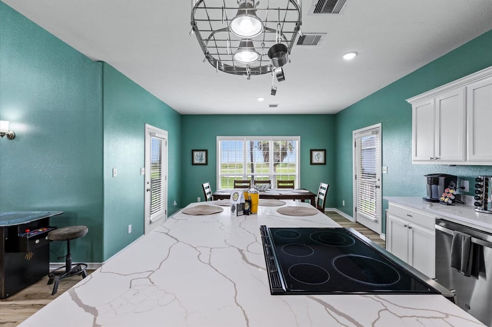 Plenty of seating at 8 person table and 4 barstools + screened in porch!