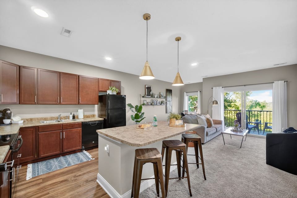 Bright open-concept kitchen and living room with balcony views