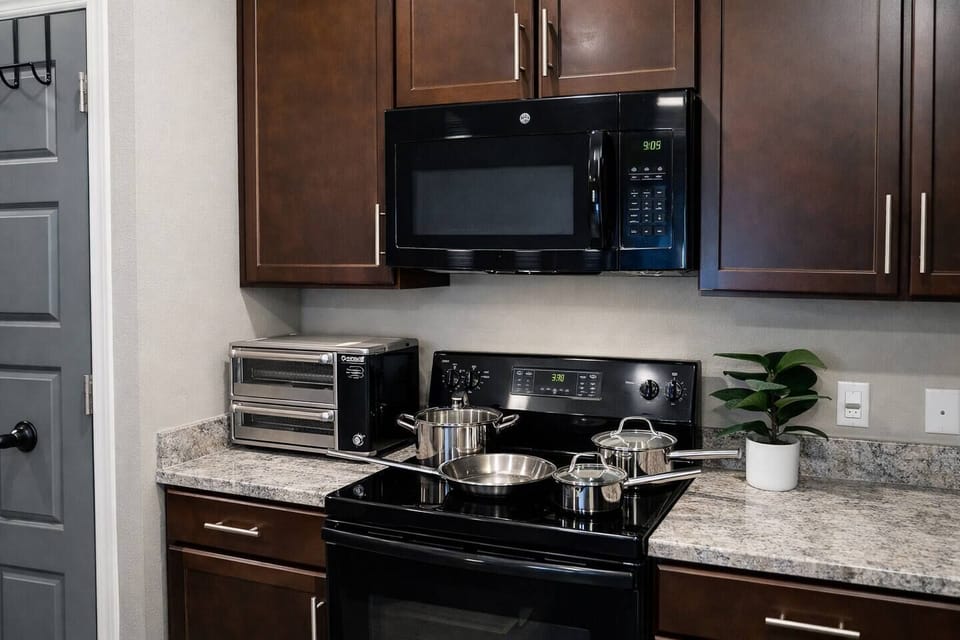 Enjoy a modern kitchen setup with stove, cookware and toaster oven for full meal flexibility.