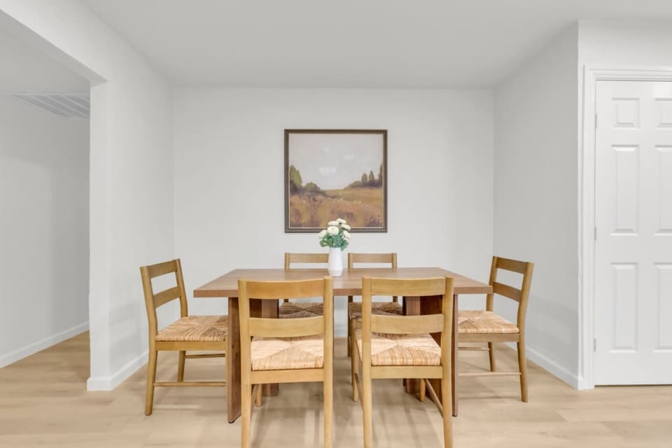 Bright dining space featuring a full dining table setup, ideal for families or groups. Centrally located for easy access to the kitchen, private living room, and air-conditioned comfort.