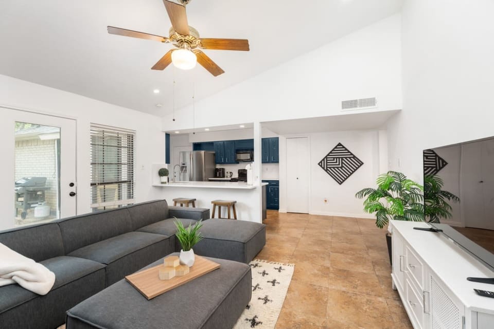 Bright and airy living room with sectional and natural light.