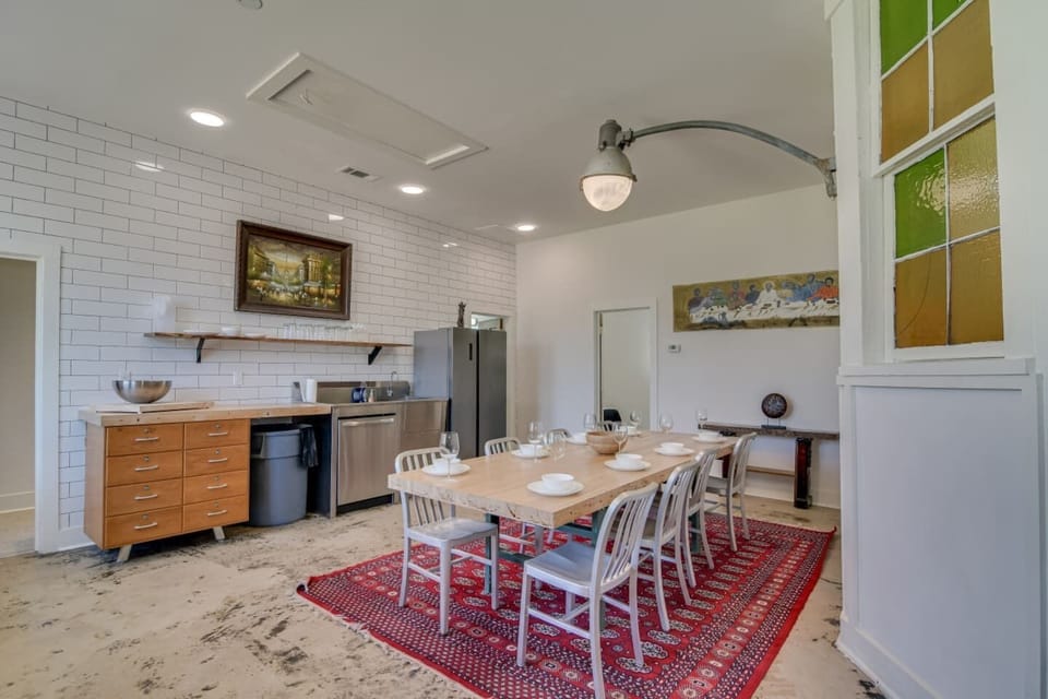 Dining hall with rustic wood table and seating for groups.