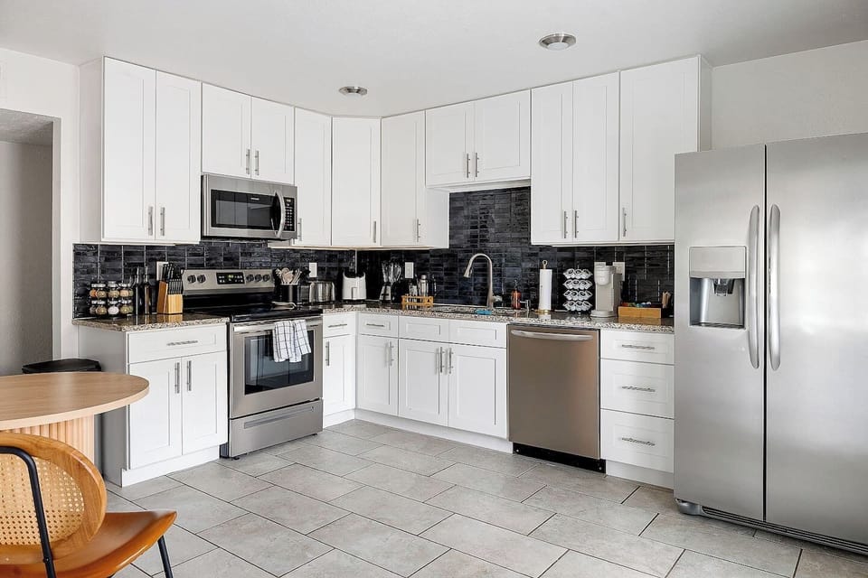This well-organized kitchen showcases stainless steel appliances and ample cabinetry. The modern design ensures both functionality and style.