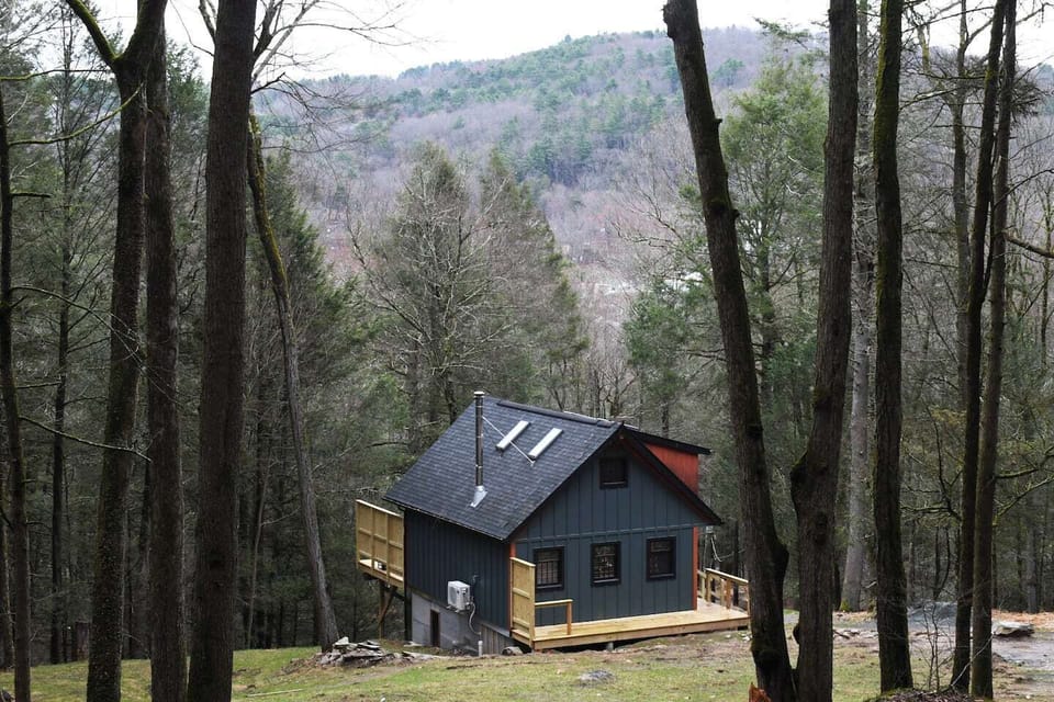 You’re truly immersed in nature here. The cabin is surrounded by towering hemlocks, providing a private, peaceful vantage point to watch the light change over the distant Catskill foothills.