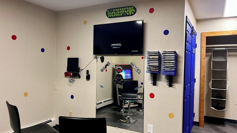 Fun game room with TV, gaming setup, and bold arcade-style decor