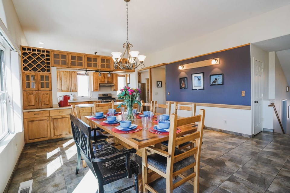 Spacious dining area perfect for family meals, flowing into a well-equipped kitchen. Gather and create lasting memories!