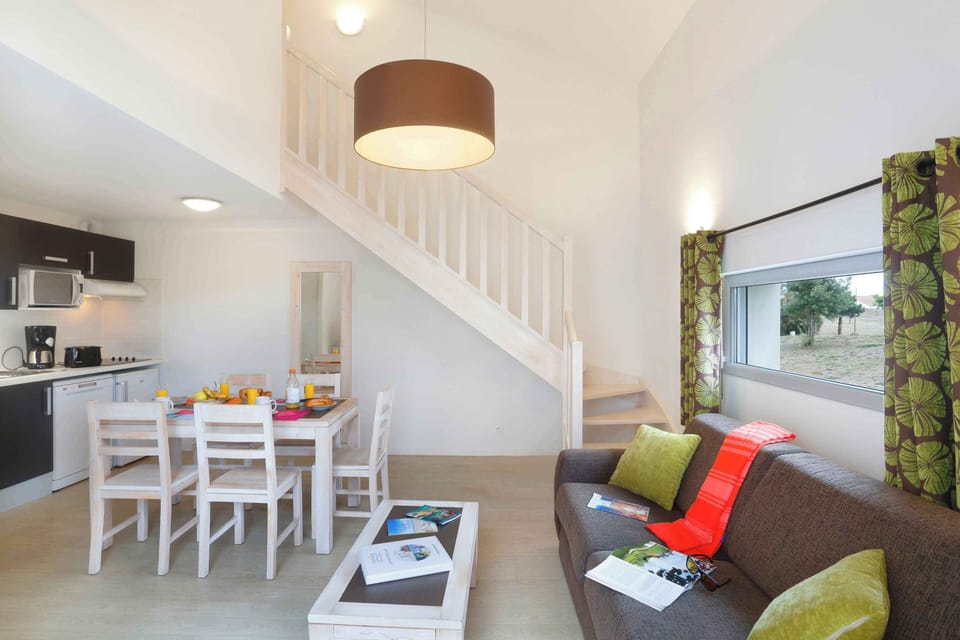 The bright living and dining area is a welcoming space for families to settle in after arriving on the Vendée coast.