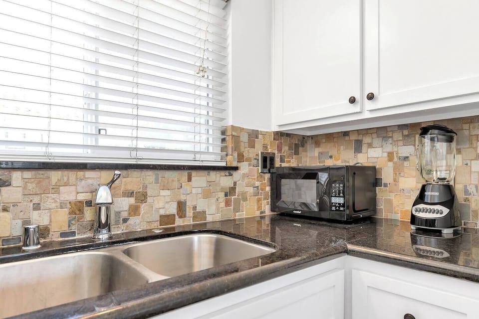 Kitchen with double stainless sink, microwave and blender