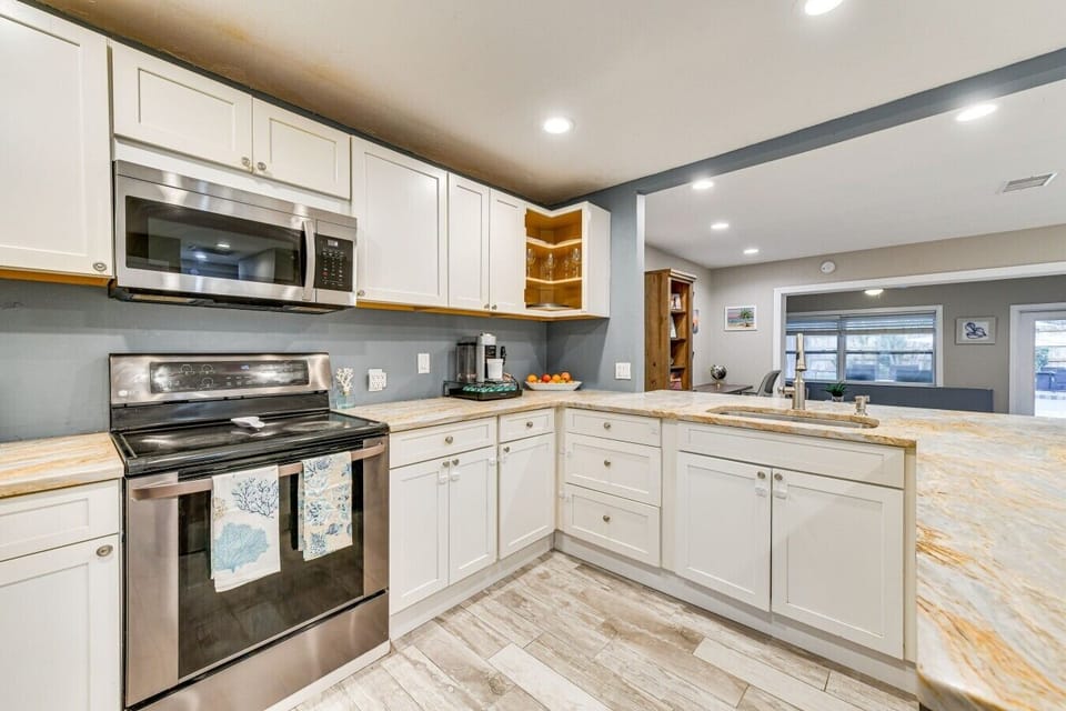 Kitchen | Stainless Steel Range & Microwave | Granite Countertops & Open Sightlines