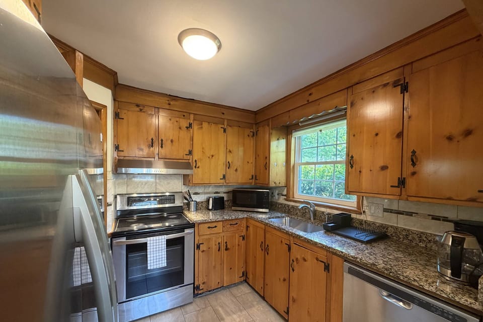 Fully stocked kitchen with fridge, dishwasher, microwave, stove and oven