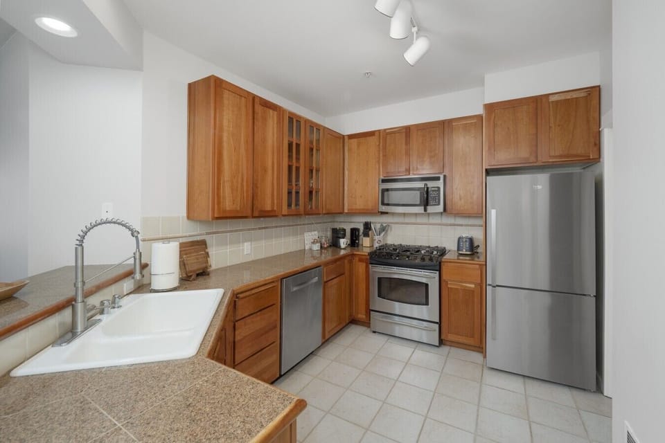 Fully equipped kitchen with stainless steel appliances.