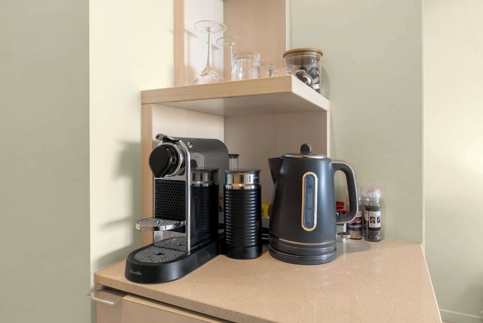 Enjoy fresh coffee or tea with a Nespresso machine and kettle provided.