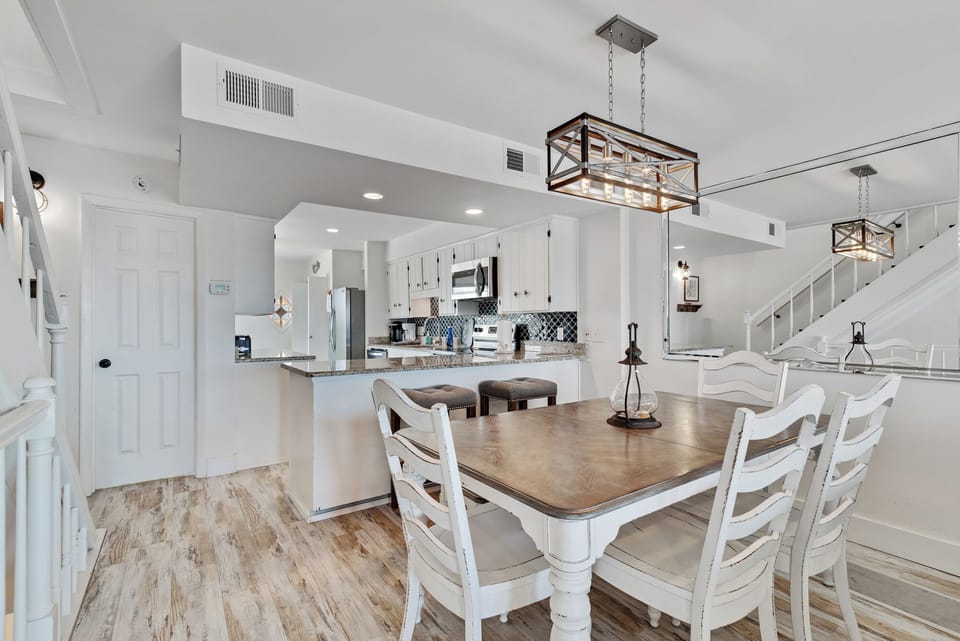 Bright open dining area with breakfast bar and stylish modern lighting
