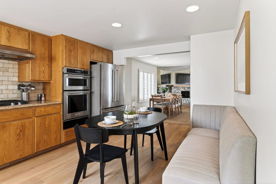 Cozy breakfast nook just off the kitchen with easy flow into the open-concept living and dining spaces.