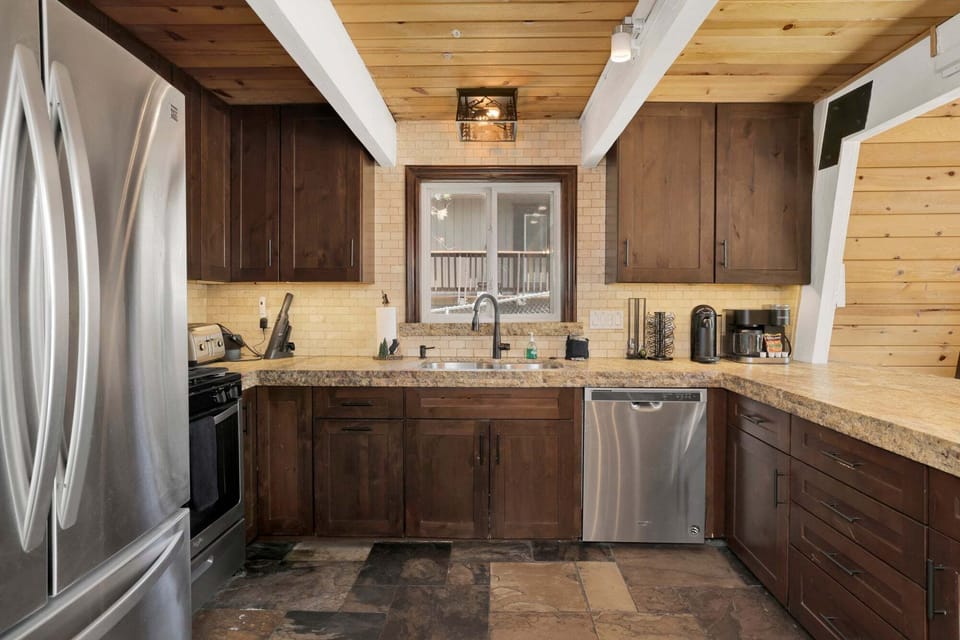 Fully equipped cabin kitchen with ample cabinetry, microwave, stove, fridge, and coffee maker, perfect for cooking meals, morning coffee, and feeling right at home during your stay.