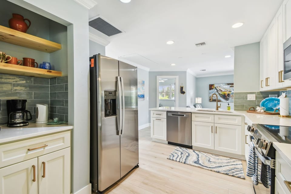Kitchen with stainless refrigerator and dishwasher
