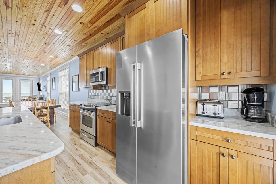 Step into your fully equipped kitchen with stainless steel appliances, coffee maker, and toaster—everything you need to start your morning or whip up a home-cooked meal.