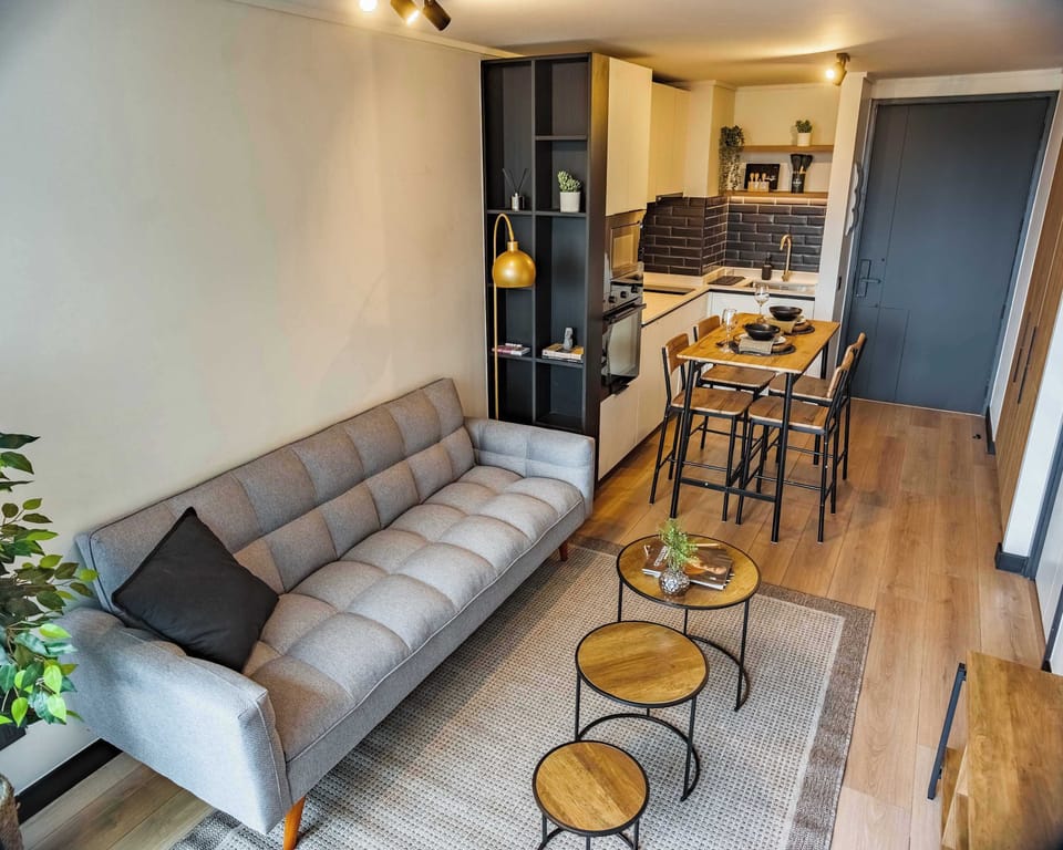 Cozy and stylish living space with modern amenities and a compact kitchen, perfect for a relaxing stay in the heart of the city.