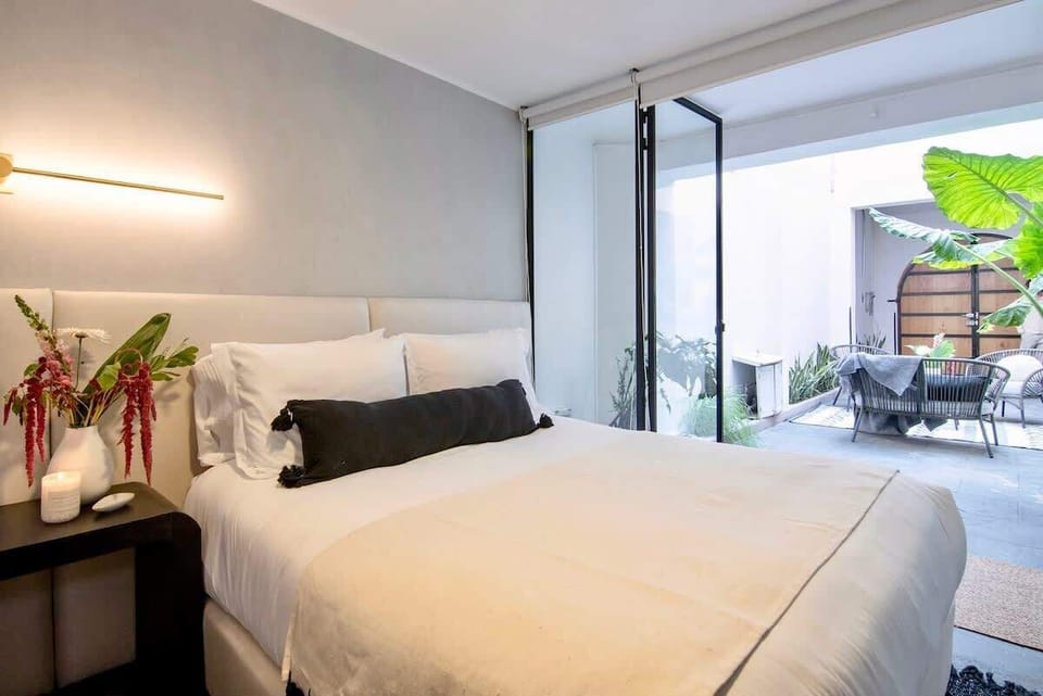 A cozy bedroom featuring a comfortable bed and soft lighting, creating a calm and inviting atmosphere perfect for restful nights.