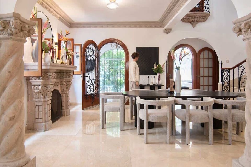 A spacious and inviting dining setting surrounded by architectural charm, perfect for gathering, entertaining, and enjoying meals in a warm and timeless environment.