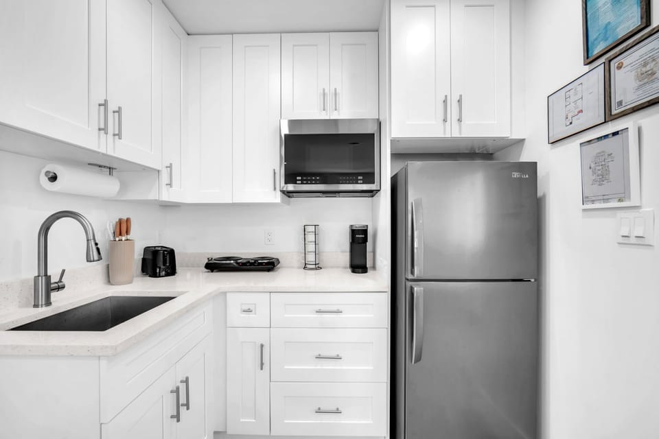 The kitchenette fully stocked with silverware, plates, and essential cookware, making it easy to prepare and enjoy meals during your stay.