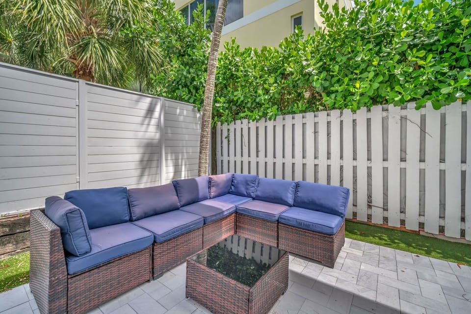 Relaxing shared patio area with comfortable seating, great for enjoying the outdoors, sipping coffee, or meeting other guests.