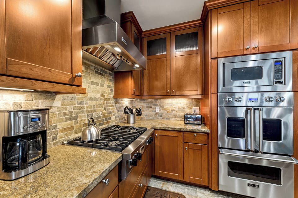 Your gourmet kitchen awaits with gleaming stainless appliances, rich cabinetry, and granite counters—perfect for preparing meals and making memories together.