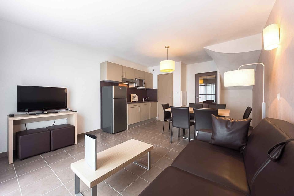 A second kitchen angle showing storage, appliances, and the dining area — everything laid out for a comfortable stay.