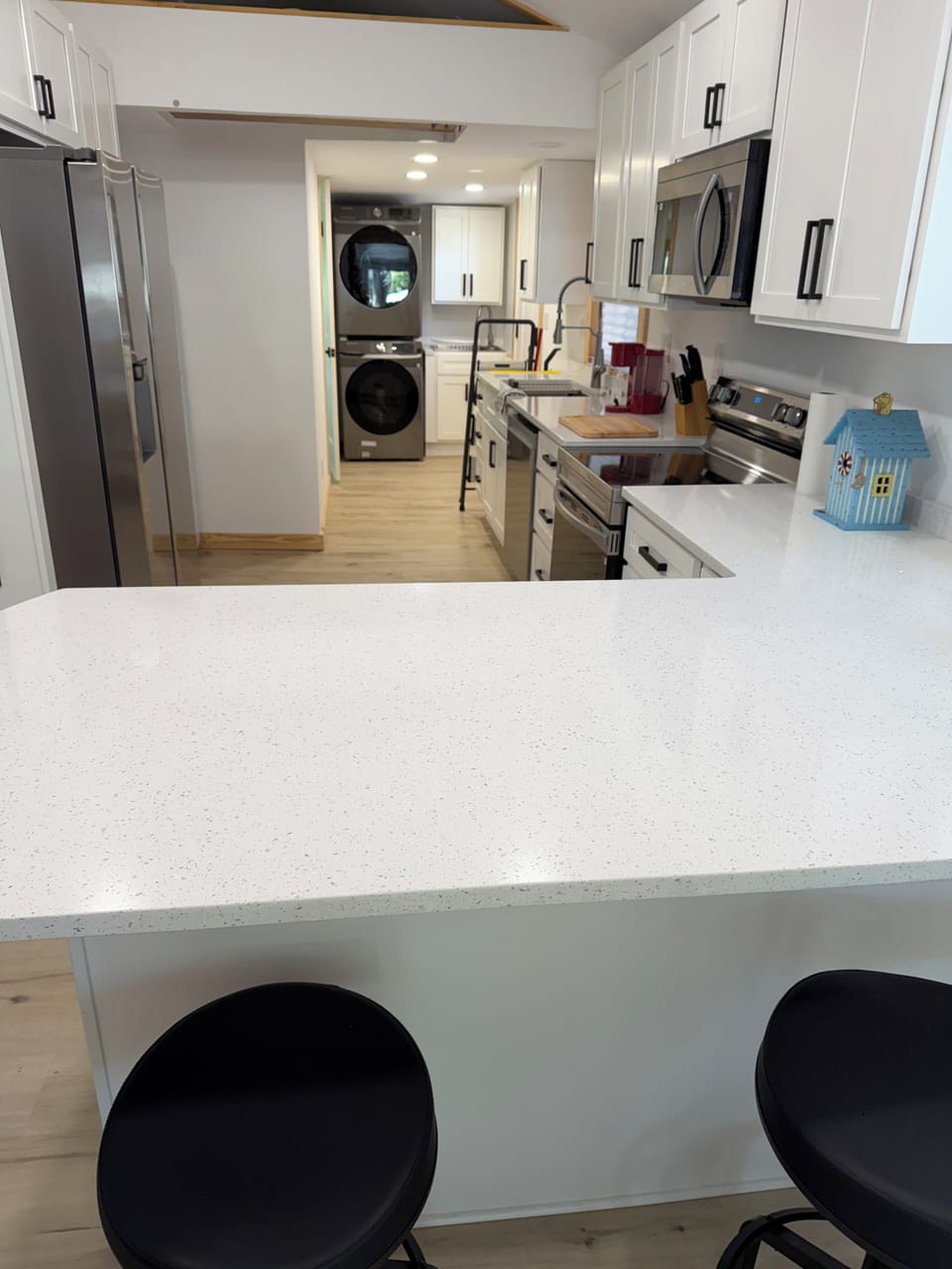 Large kitchen with all new appliances and full laundry. 