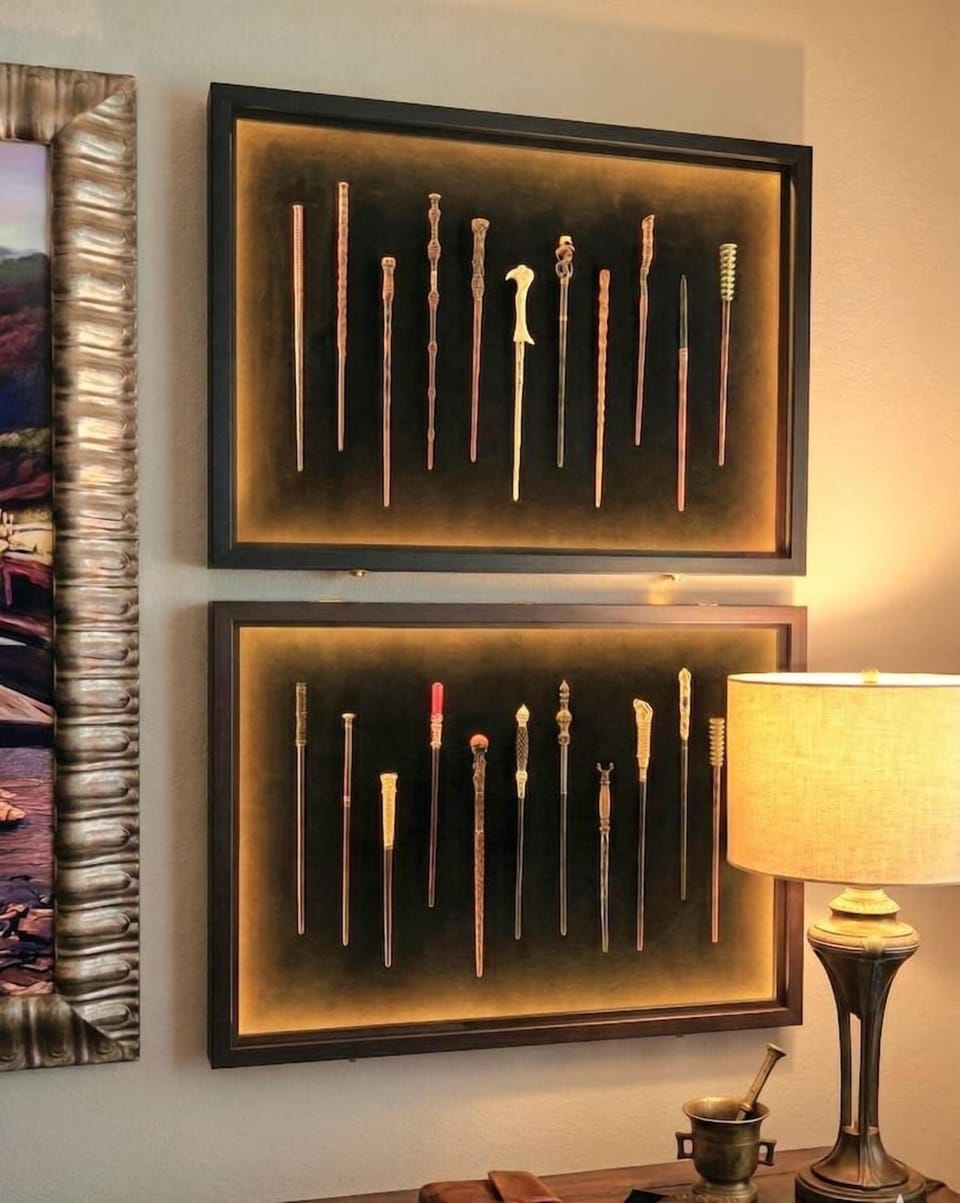 Two LED-lit shadow boxes display a curated collection of character wands that shift color as you walk by. Fans will recognize the order — everyone else will just think they're beautiful.