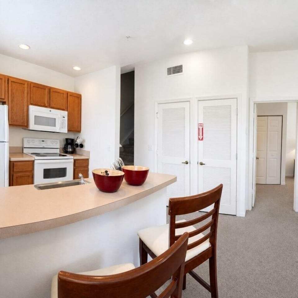 Cozy kitchen with breakfast bar, ideal for morning coffee or quick meals.