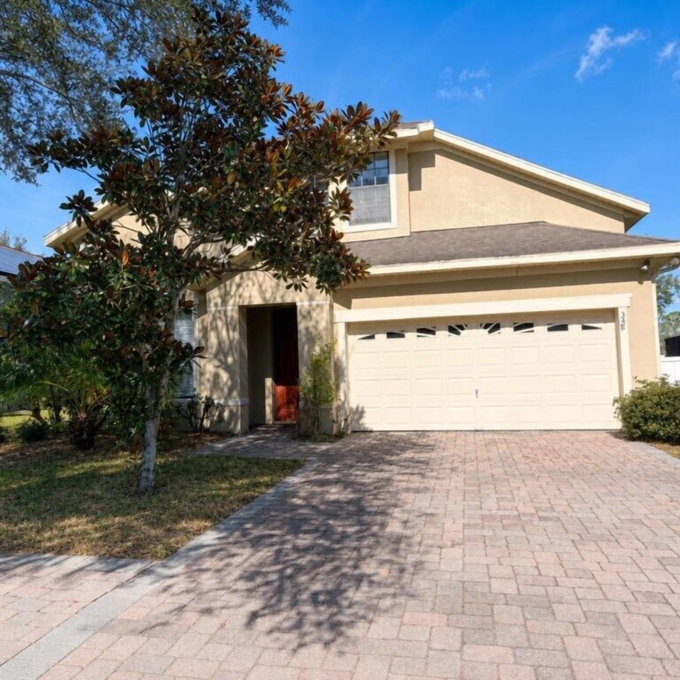 Charming home with spacious driveway and inviting entrance.