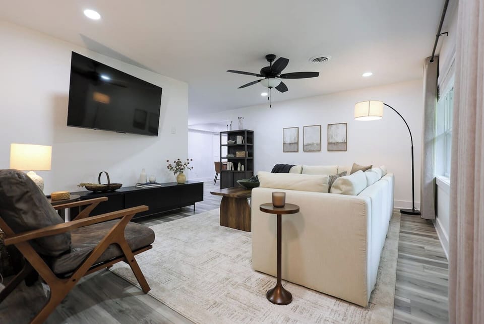 Living room with oversized sofa and a 65" Smart TV, perfect for relaxing