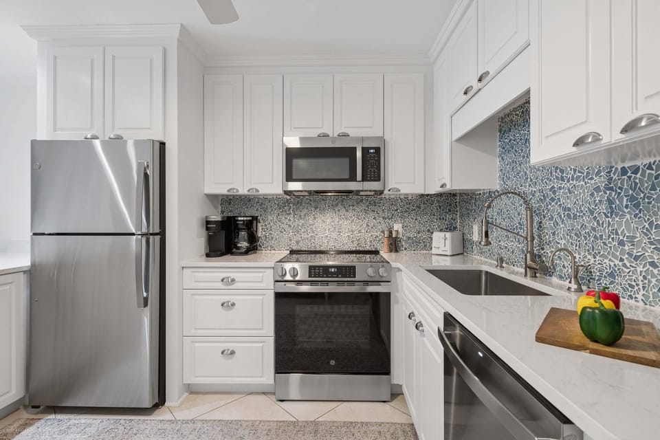 Fully-equipped kitchen with essential cookware and dining items