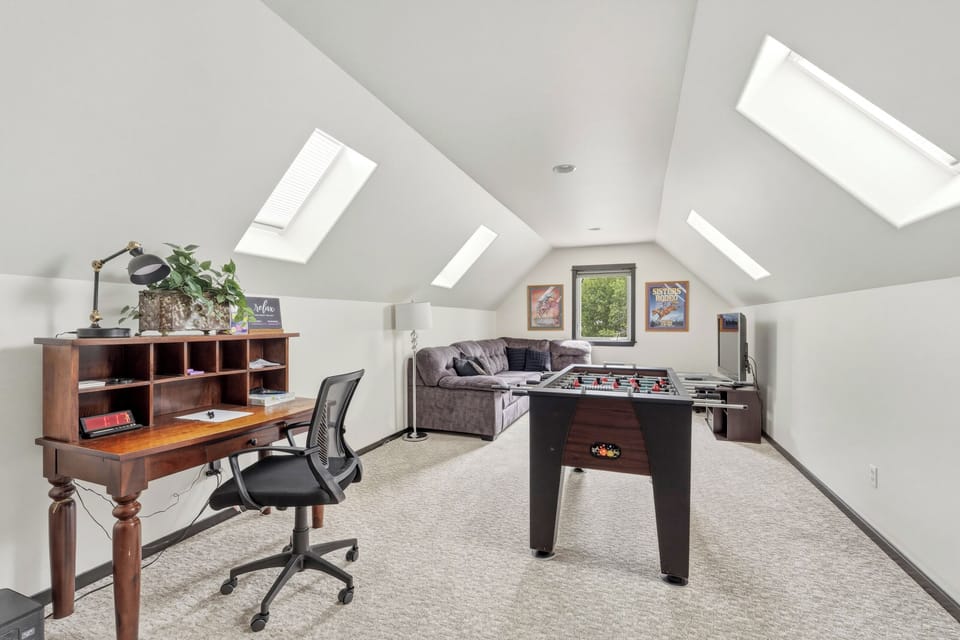 Game Room: Unleash fun in this bright loft with foosball, comfy seating, and a desk workspace!