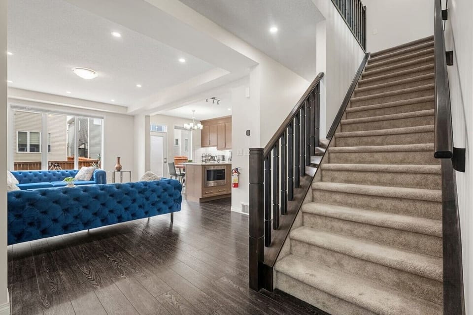 Spacious foyer with grand staircase connecting to living areas
