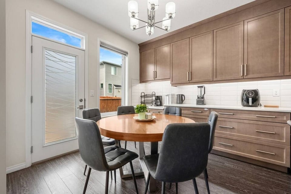 Well-equipped kitchen featuring round dining table and patio doors
