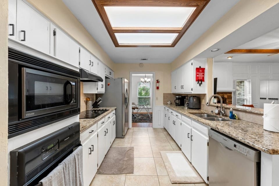 Clean, bright kitchen with skylight views—perfect for easy meals, quick snacks, and recharging between game-day moments.