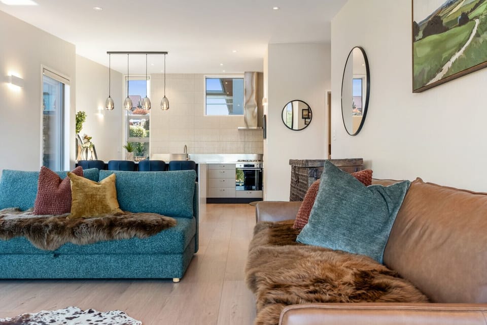 The living room - open plan, two sofas, kitchen island behind